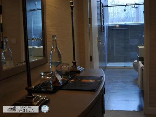 a bathroom with a counter with two bottles on it at Pacheca The Wine House Hotel e Spa - Quinta da Pacheca in Lamego