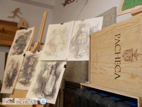 a wooden cutting board with drawings on a wall at Pacheca The Wine House Hotel e Spa - Quinta da Pacheca in Lamego