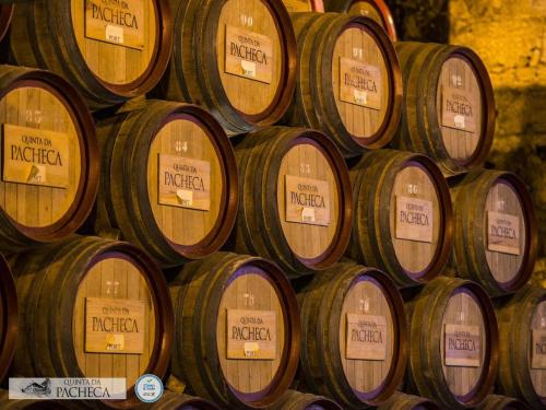a bunch of wine barrels stacked in a pile at Pacheca The Wine House Hotel e Spa - Quinta da Pacheca in Lamego