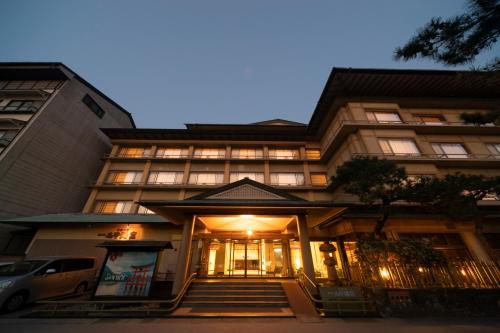 a building with the front of it at night at Hotel Miya Rikyu in Miyajima