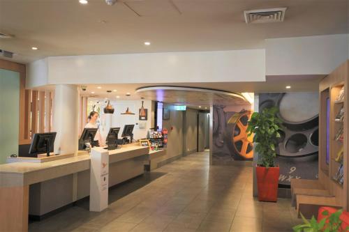 a lobby of a store with a waiting room at ibis Sydney Airport in Sydney