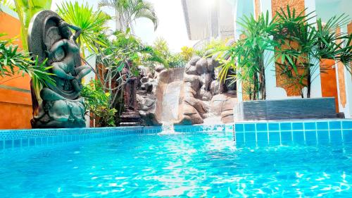 a swimming pool with a fountain in a building at JOOPLAND Luxury Pool Villa Pattaya Walking Street in Pattaya South