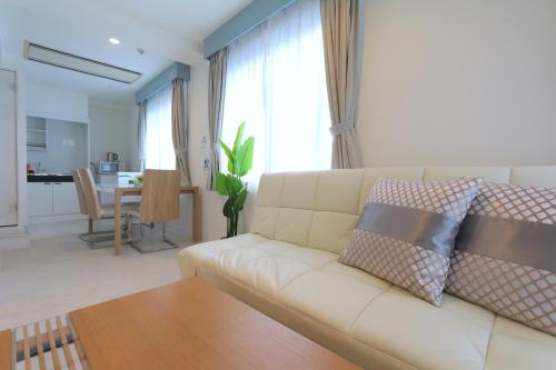 a living room with a white couch and a table at NM21 Liz Osaka Castle in Osaka