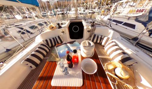 a table on a boat with food and drinks on it at Charming Boat in Funchal with Sea View in Funchal