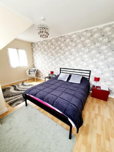 a bedroom with a large purple bed and a wall at Chambres Dhôtes Numéro 1 in Châteaulin
