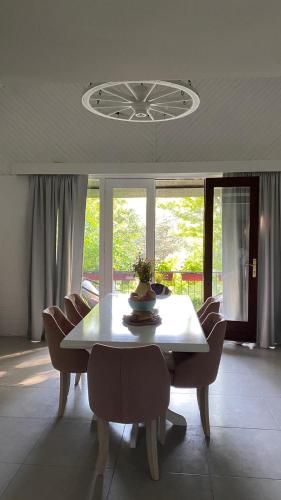 a dining room with a white table and chairs at Agape Glamping in Velika Remeta