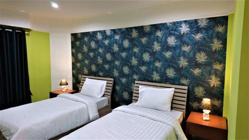 โรงแรมเมืองเพรียวอินน์ Mueang Phriao Inn Hotelにあるベッド