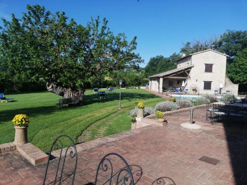 a view of a park with a building and a yard at Parco Ducale Country House in Urbania