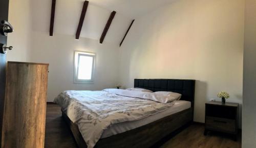a bedroom with a bed in a room with a window at Guest House Markovic Lovcen in Cetinje