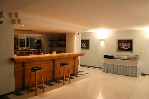 a bar in a restaurant with two bar stools at Cape Kanapitsa Hotel & Suites in Kanapitsa