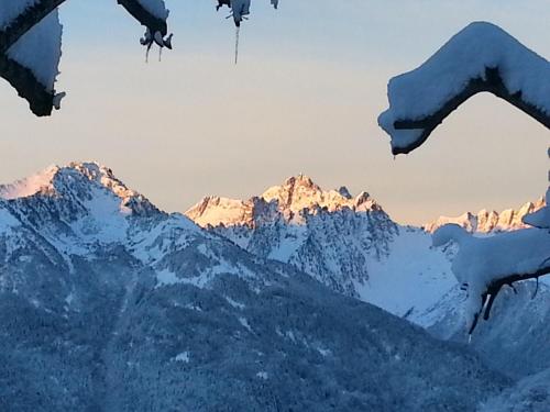 a snowy mountain range with snow covered mountains in the background at Hôtel Le Beauséjour in Saint-François-Longchamp