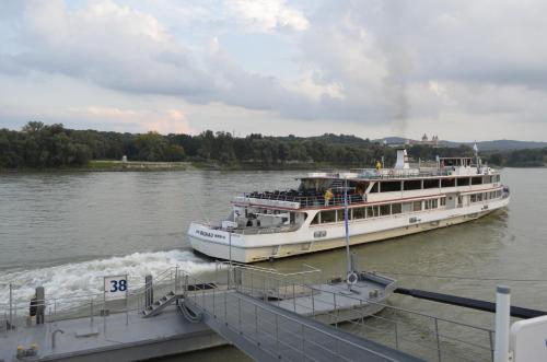 two boats are docked at a dock on the water at Hotel Donauhof in Emmersdorf an der Donau