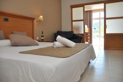 a bedroom with a large bed and a chair at Cyprotel Faliraki in Faliraki