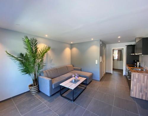 a living room with a couch and a table at Kragerø Sportell & Apartments in Kragerø