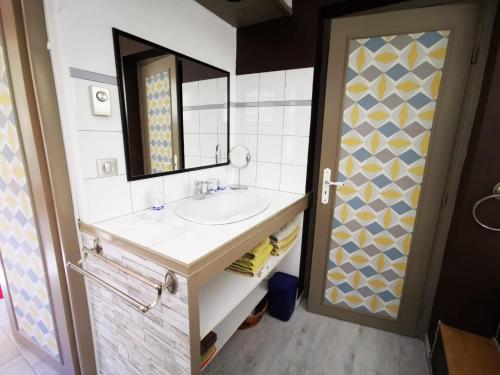 a bathroom with a sink and a mirror at Chambre D'Hotes Au Coquelicot in Soucieu-en-Jarrest