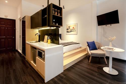 a small kitchen with a bed in a room at Central Studios at Ben Thanh Market by CIRCADIAN in Ho Chi Minh City