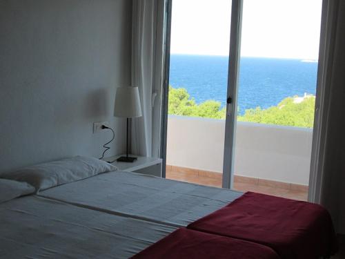 a bedroom with a bed and a large window at CASA ANA in Sant Josep de Sa Talaia