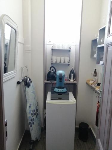 a small kitchen with a blue appliance on a counter at Chambres d'Hôtes de luxe Côté Parc-Côté Jardin avec parking privé gratuit in Nevers