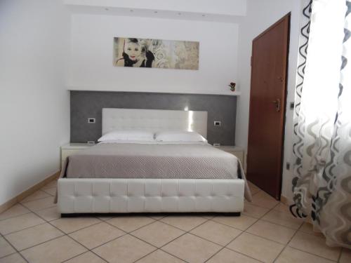 a bedroom with a large white bed in a room at Acquamarina B&B in Martinsicuro