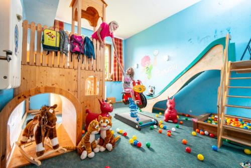 a childs room with toys and a play room with a castle at Familien-Appartements Örglwirt's Gut in Mariapfarr