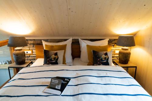 a bedroom with a bed with two people sitting on it at Ferienhäuser Saalemaxx in Rudolstadt