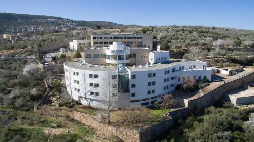 an aerial view of a large white building at HI - Pkiin Hostel in Buqei‘a