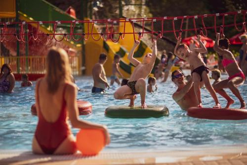 a group of people in the water at a swimming pool at Danubius Hotel Marina in Balatonfüred