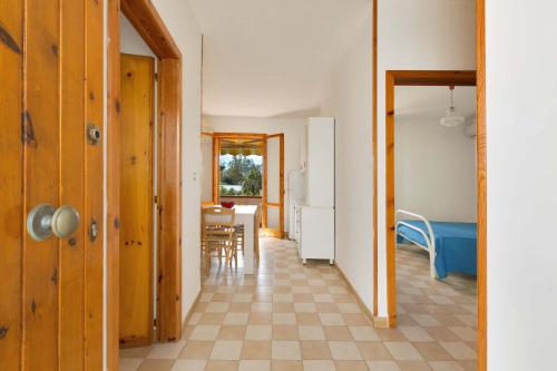 a hallway with a kitchen and a dining room at Casa Di Ronzino by BarbarHouse in San Foca