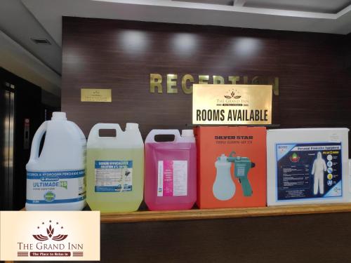 a shelf with several bottles of detergents on it at The Grand Inn Mysore in Mysore