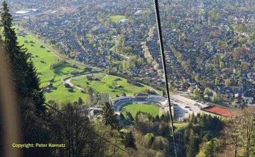 a view of a city from the top of a mountain at Olympiahaus in Garmisch-Partenkirchen