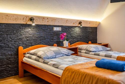 ザコパネにあるOW Willa Piotr Zakopaneのレンガの壁の客室内のベッド2台