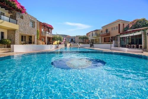 a large swimming pool in the middle of a building at Stefan Village Hotel in Agia Marina Nea Kydonias