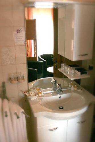 a bathroom with a sink and a mirror at Pension Wolfgangsee in St. Wolfgang