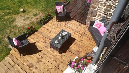an overhead view of a deck with chairs and a table at La Gerbaudiere Chambres&Table d hotes proche Mont Saint Michel CUISINE MAISON in Notre-Dame-du-Touchet