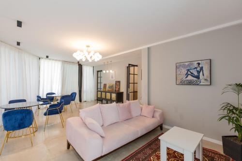 a living room with a couch and a table at Hotel Lifetime in Batumi