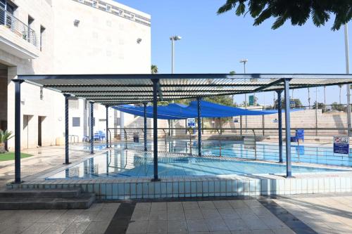 a swimming pool with a blue cover over it at HI - Beit Shean Hostel in Bet Sheʼan