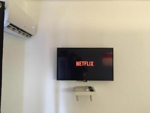 TV de pantalla plana colgada en la pared en House Italy en Siófok