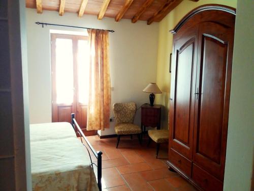 a bedroom with a bed and a window and a chair at Marco & Andrea Agriturismo Collepina in Amelia