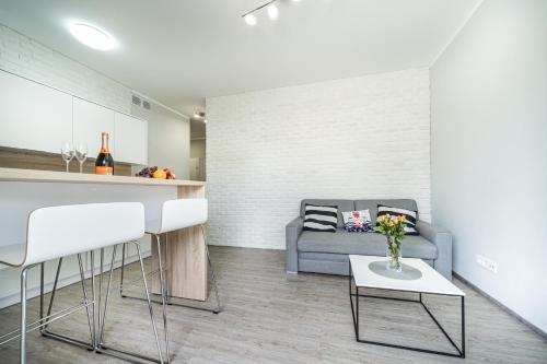 a living room with a couch and a table at Baltic Apartments in Pobierowo