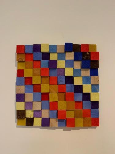 a colorful puzzle piece hanging on a wall at Le Vie Mediterranee in Torre di Ruggiero