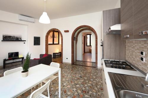 a kitchen and living room with a table and a stove at Casa Pirri in Castelmola