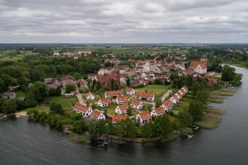 an aerial view of a town on an island in the water at ApartView na Mazurach "Osada Zamkowa" by Rent like home in Pasym