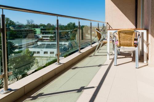 a balcony with chairs and a view of a harbor at Rezident Eforie Nord in Eforie Nord