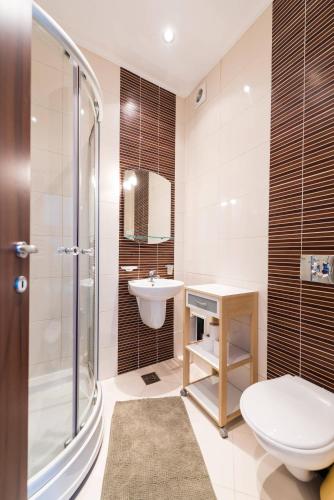 a bathroom with a toilet and a sink and a shower at Rezident Eforie Nord in Eforie Nord
