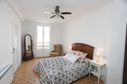 a bedroom with a bed and a ceiling fan at Casa Font in Benissanet