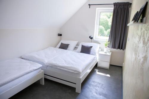 Postel nebo postele na pokoji v ubytování Apartmány U tří bratrů