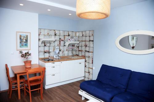 a kitchen with a blue couch and a table at Tanya-Apartments and Rooms in Hvar