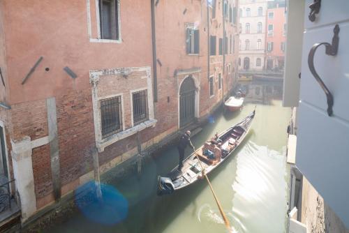 a group of boats are docked in a canal at Apartments in San Marco with Canal View in Venice