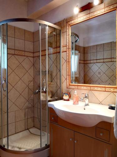 a bathroom with a sink and a shower at VILLA TASOS in Iraklitsa