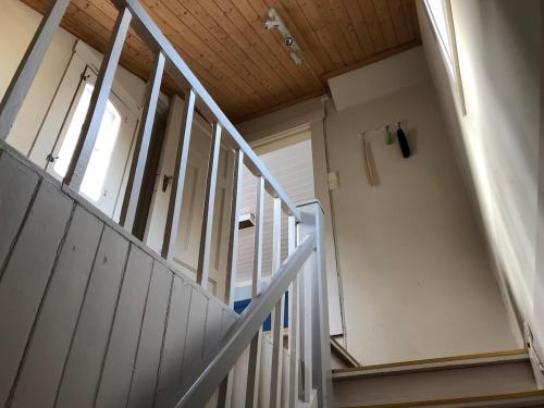 a white staircase in a building with a door at The Arctic Villa in Tromsø in Tromsø
